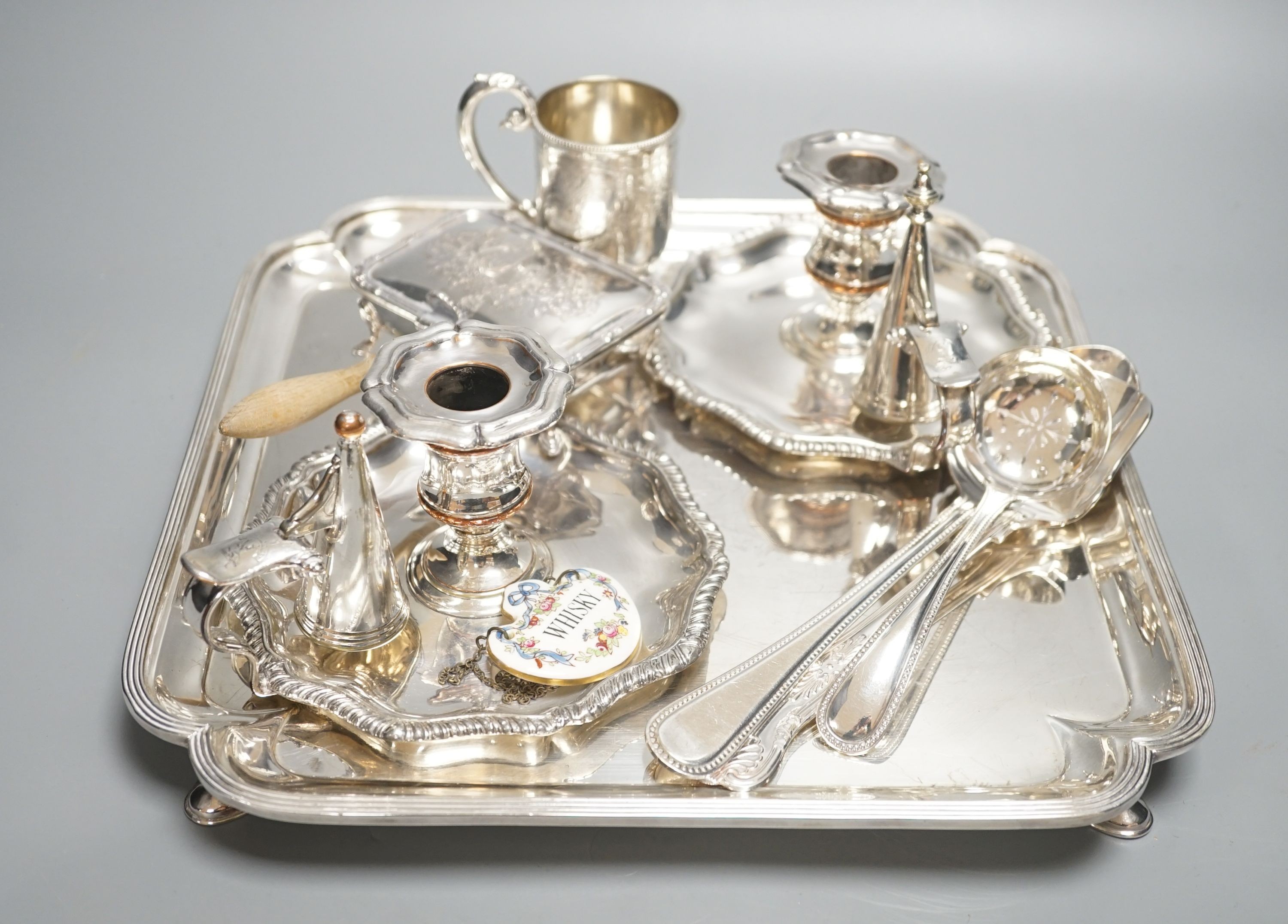 A plated salver, a pair of chambersticks and other plated flatwares